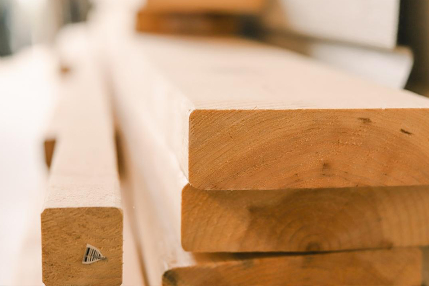 Focus on a stack of neatly cut lumber planks.